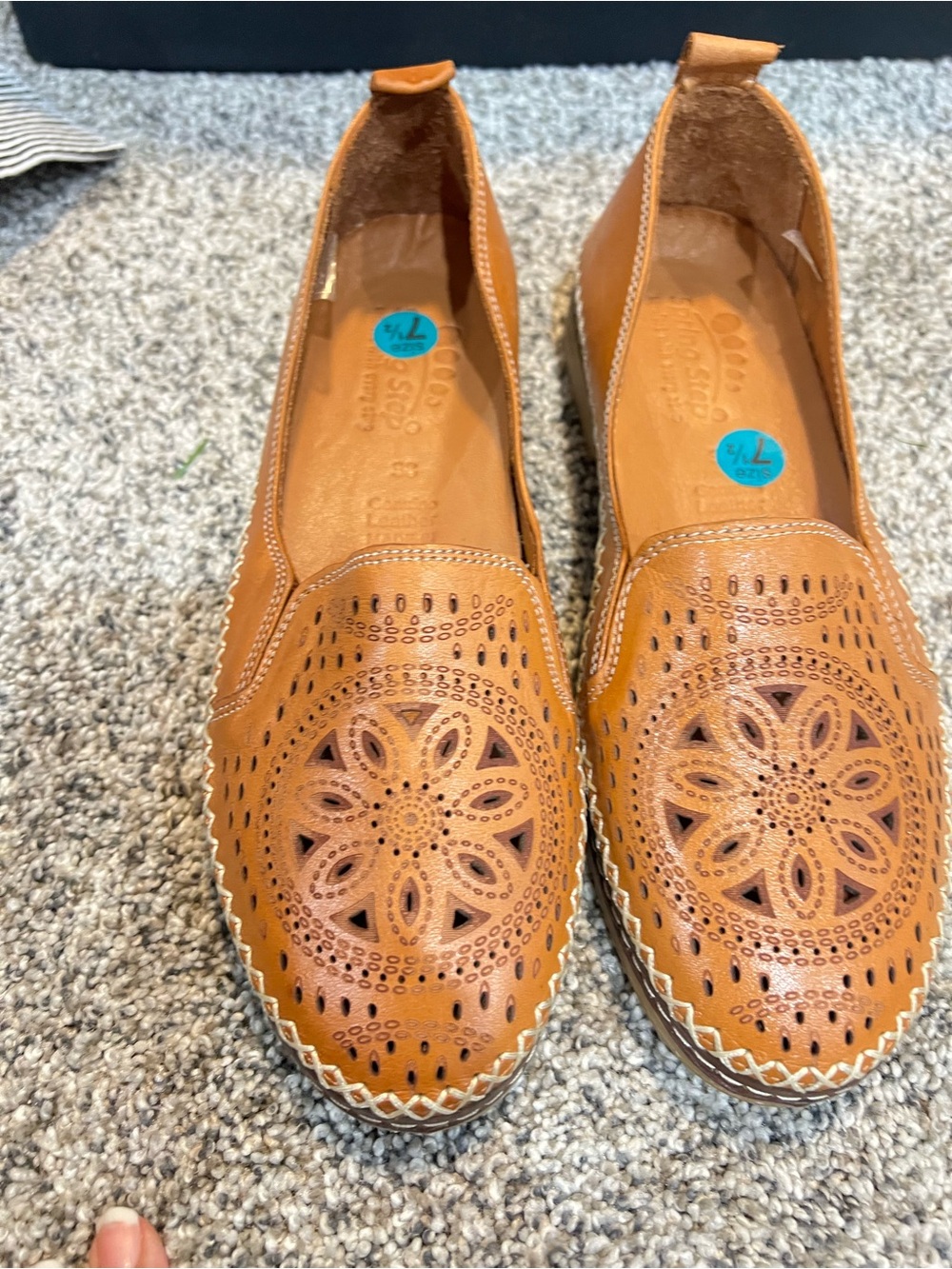 Spring Step Ingrid slip-on loafers feature a detailed laser cutout design